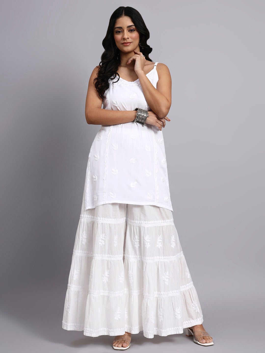 Front view of Woman wearing a white outfit with a plain background