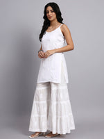 Side view of Woman wearing a white outfit with a plain background