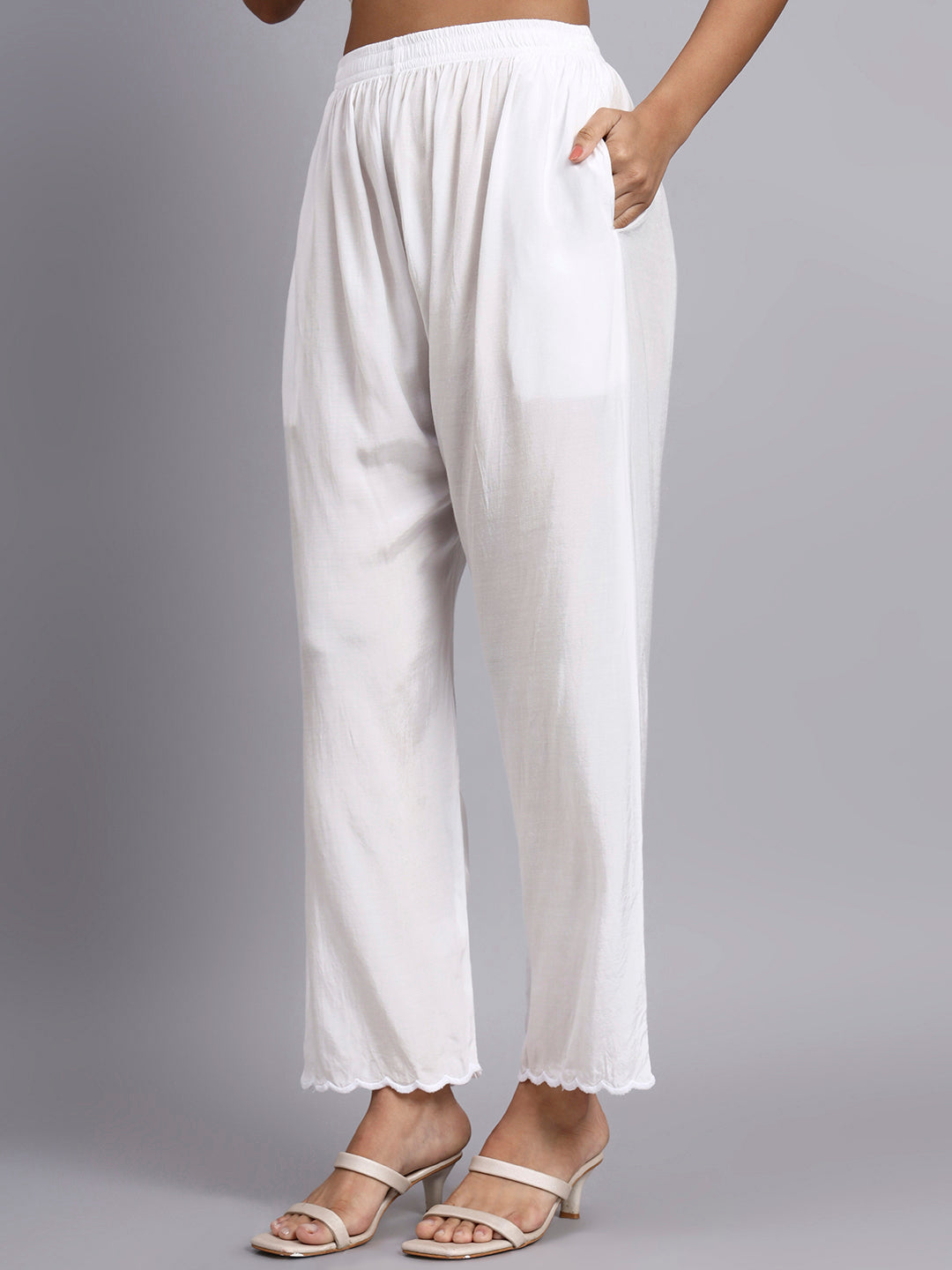 White wide-leg pants worn by a person on a gray background