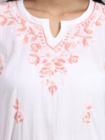 Close up view of White top with pink floral embroidery