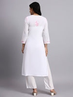Back view of Woman wearing a white chikankari kurta with pink embroidery on a gray background