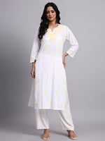 Full look of Woman wearing a white kurta with yellow floral patterns on a gray background