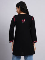 Back view of Black kurta with pink floral embroidery on a gray background