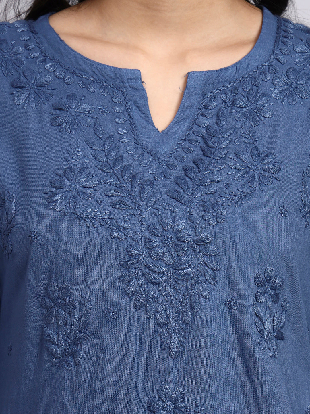 Close up view of Blue embroidered garment with intricate patterns