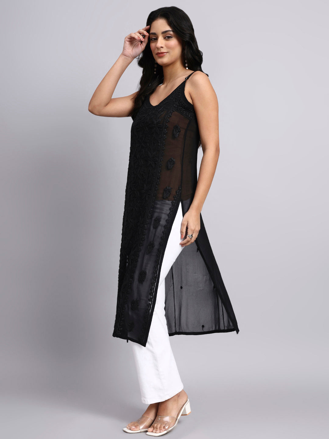 Side view of Woman wearing a black long kurti with sheer sides on a gray background