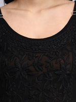 Black embroidered dress with a close-up of the neckline