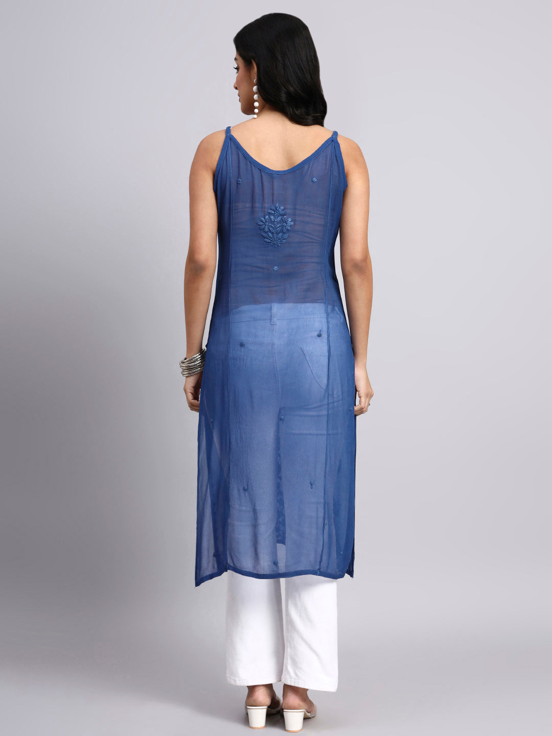 Back view of Woman wearing a blue kurta with white pants on a gray background