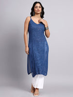 Full view of Woman wearing a blue lace dress with a white bottom on a gray background