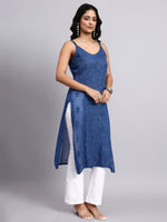 Side view of Woman wearing a blue sleeveless kurti and white pants on a gray background