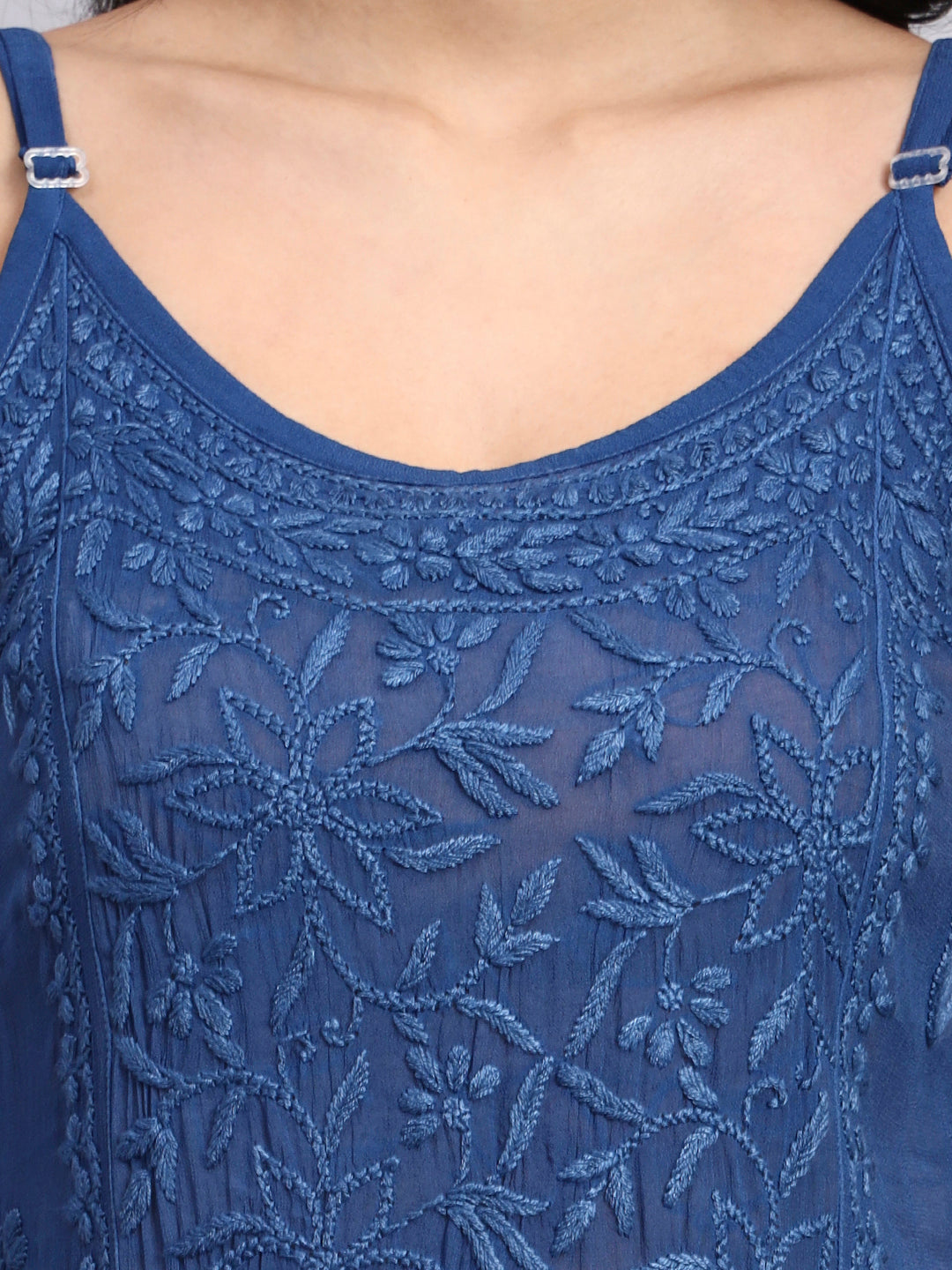 Close-up of a blue lace dress with floral patterns