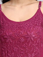 Close-up of a maroon embroidered top with floral patterns