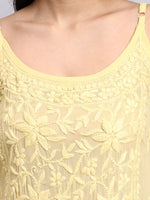 Close up view of Yellow lace top with floral patterns