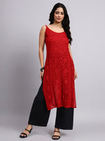 Full view of Woman wearing a red sleeveless chikankari long kurta and black pants on a gray background