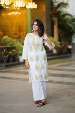 Front view of Snapfab's white Lucknowi Chikankari cotton kurta, featuring delicate beige thread embroidery, paired with comfortable white palazzos. 
