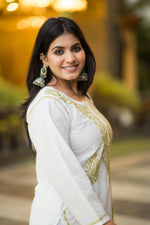 Side view of Snapfab's fashionable white Chikankari kurta, showcasing the comfortable fit and exquisite beige embroidery detail.