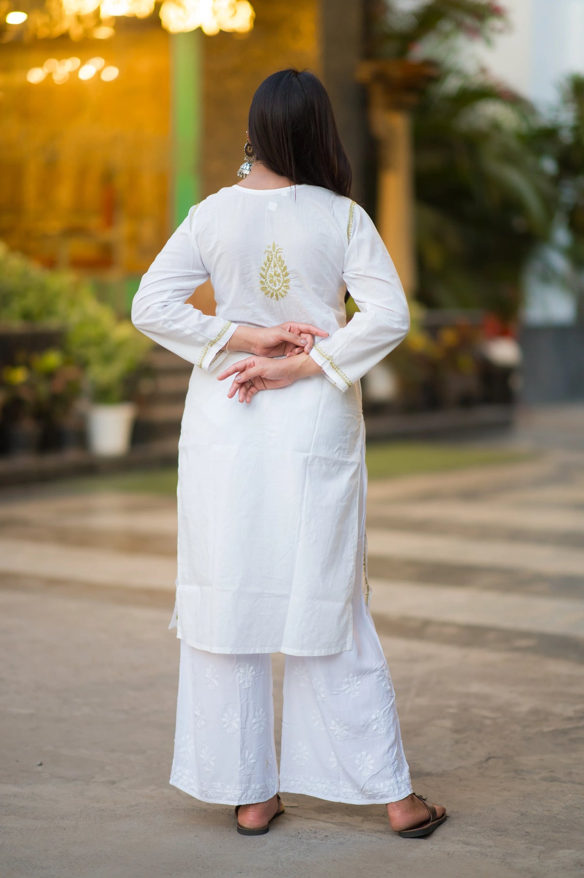 Back view of Snapfab's classic white Lucknowi Chikankari cotton kurta, featuring subtle beige embroidery on the back, paired with embroidered white palazzos.