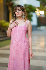 Front view of a woman in a flowy pink Noora Noodle strap kurti, highlighting its modern design.