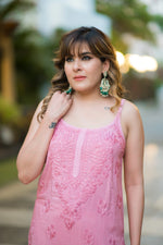 Front view of a woman in a pink Noora Noodle strap kurti, a stylish Indian outfit.