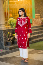 Angled view of a woman in a Riwayat kurti and white pants, a popular ethnic outfit.