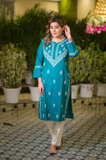 A full front shot shows a model in a teal blue kurta with white traditional chikankari work, paired with white pants. 