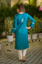 The back view shows a woman in a teal blue long kurta with a single white embroidered motif on the upper back. 