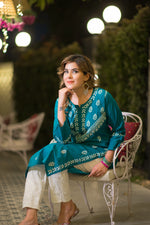 A seated close-up shows a woman in a teal blue kurta with white embroidery, resting her chin on her hand.
