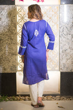 Back full shot of a woman in a blue riwayat kurta and white pants with white embroidery.