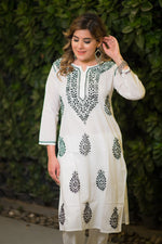 Full shot of a model in a white mulmul cotton kurta featuring black floral and paisley designs.