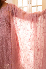 Close-up Flowing organza dupatta with intricate embroidery. View traditional attire, organza fabric, party wear.