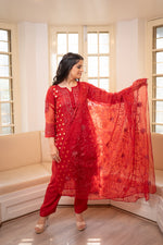 Front view Red organza suit. Stylish embroidered organza kurta set for festive occasions, trending ethnic wear.