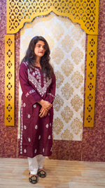 Angled view of a wine Chikankari kurti, showcasing its soft texture and elegant ethnic design.