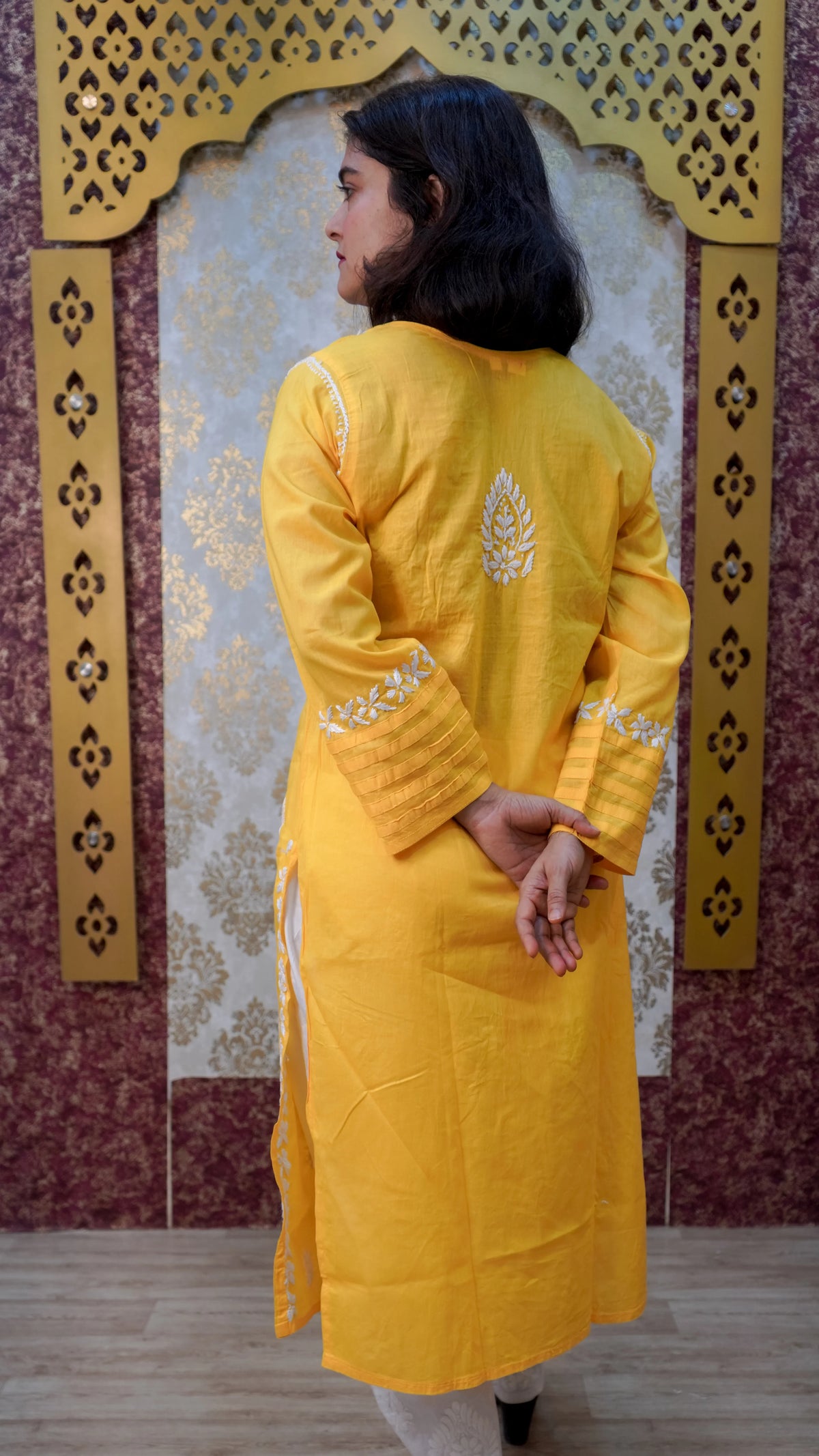  Back view of a stylish double-layer yellow kurti, showcasing its unique design and elegance, perfect for modern ethnic wear.