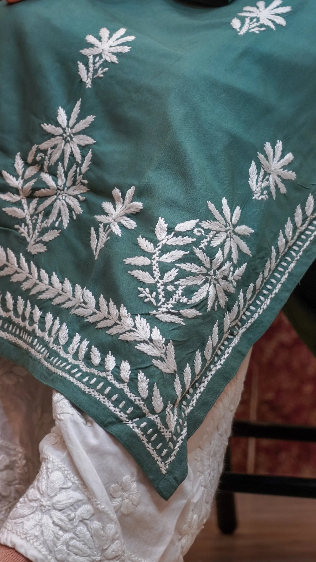 Close shot of a pista green Modal Chikankari Kurti, breathable cotton-based fabric, ideal for ethnic wear.