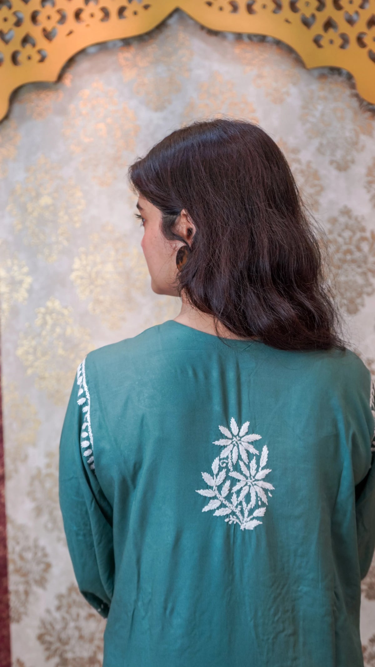Back view of a pista green Modal Kurti, showcasing flowy Modal Rayon and Chikankari Ghasspatti handwork.