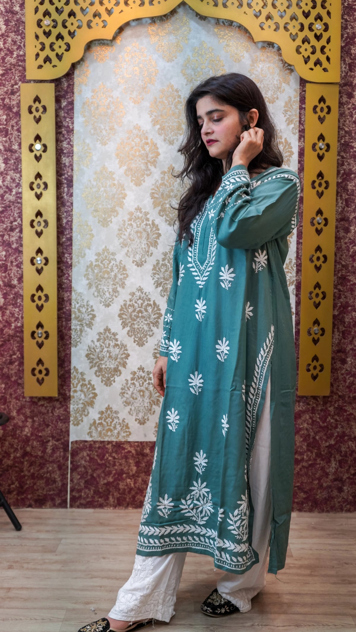 Side view of a pista green Modal Chikankari Kurti, a comfortable ethnic tunic with hand embroidery.