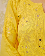 Close-up of breathable viscose georgette fabric from a white Mirror Work Set. Light and comfortable.