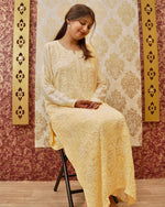 View a luxurious beige & yellow viscose georgette kurti set. Showcases dazzling hand embroidery with sequins.
