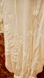 View a comfortable white Afghani pant with a flowy drape. Perfect ethnic bottom wear for women.