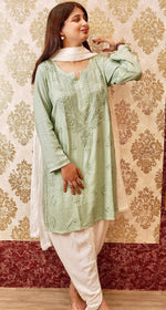 Front view of pista green short cotton kurta with white dupatta and pants & with Chikankari embroidery.