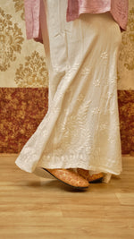 Close-up of the unique Kali cut and Lucknowi embroidery on a white palazzo. Comfortable bottom pants for women.
