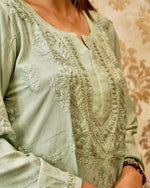 Pista green Chikankari kurta with delicate floral embroidery.
