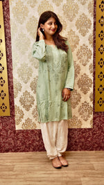 Close-up of intricate Lucknowi Chikankari handwork on a white Afghani pant. Exquisite bottom pants.