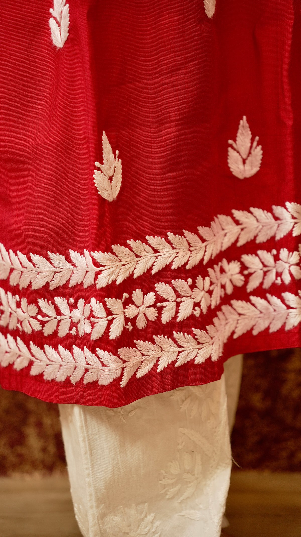 Close-up of suit embroidery design. View intricate traditional motifs on a cotton lycra fabric.