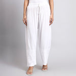 White wide-leg pants worn by a person on a plain background