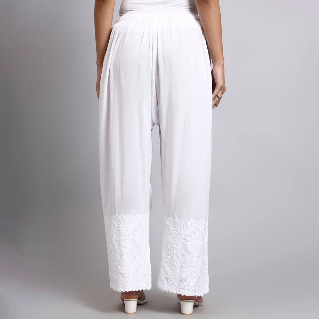 White wide-leg pants worn by a person on a plain background