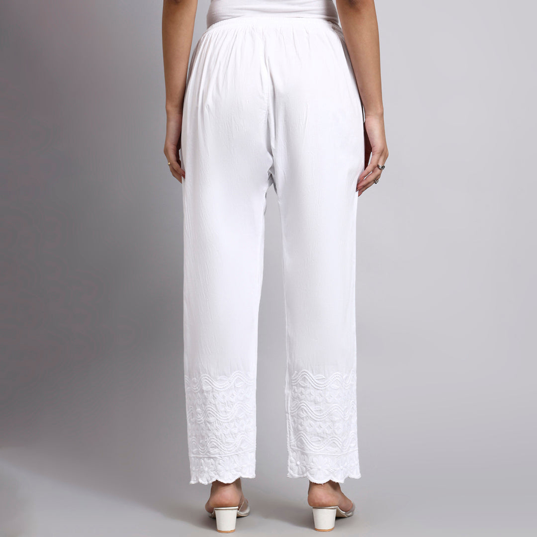 White wide-leg pants worn by a person on a gray background