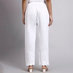 White wide-leg pants worn by a person on a gray background