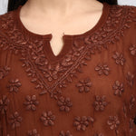 Zoom view of Brown embroidered top with floral patterns on a plain background