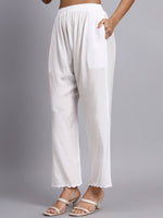 White wide-leg pants worn by a person on a gray background