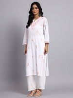 Side view of Woman wearing a white kurta with floral embroidery on a gray background